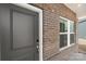 Contemporary front door featuring brick accents, sidelight, and a modern aesthetic for a great first impression at 117 Obadiah Ct, Troutman, NC 28115