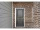 Stylish front door with a brick facade, offering a welcoming entrance to this beautiful home at 117 Obadiah Ct, Troutman, NC 28115
