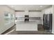 Kitchen with granite island, stainless appliances, and white cabinets at 117 Obadiah Ct, Troutman, NC 28115