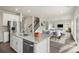 Modern kitchen with granite countertops, stainless steel appliances, and an island that opens up to the dining area at 117 Obadiah Ct, Troutman, NC 28115