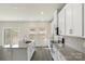Bright kitchen with granite countertops, stainless steel appliances and white cabinets at 117 Obadiah Ct, Troutman, NC 28115