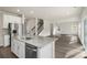 Kitchen island featuring granite countertops, wood floors, and stainless appliances at 117 Obadiah Ct, Troutman, NC 28115