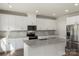 Modern kitchen with granite counters, white cabinets, and stainless steel fridge at 117 Obadiah Ct, Troutman, NC 28115