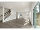 Spacious living room with stairs and luxury vinyl plank flooring at 117 Obadiah Ct, Troutman, NC 28115