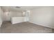 Neutral carpet in the second floor loft features many windows at 117 Obadiah Ct, Troutman, NC 28115