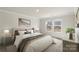 Cozy main bedroom with natural light, a comfortable queen-sized bed, and minimalist decor for a relaxing atmosphere at 117 Obadiah Ct, Troutman, NC 28115