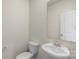 Stylish powder room features a pedestal sink, a mirror, and a toilet at 117 Obadiah Ct, Troutman, NC 28115