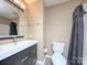 Bathroom with vanity, toilet, and tiled shower/tub with gray shower curtain at 11911 Maria Ester Ct, Charlotte, NC 28277