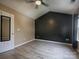 Bedroom with a black accent wall, ceiling fan, and light wood-look flooring at 11911 Maria Ester Ct, Charlotte, NC 28277