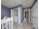 Hallway laundry closet with white washer and dryer set, neutral gray walls and light wood-look flooring at 11911 Maria Ester Ct, Charlotte, NC 28277