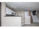 Open kitchen with stainless steel appliances, granite countertops, and white cabinetry at 11911 Maria Ester Ct, Charlotte, NC 28277