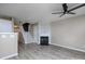 Spacious living room with a cozy fireplace, ceiling fan, and stairs leading to the upper level at 11911 Maria Ester Ct, Charlotte, NC 28277