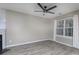 Neutral living room with a fireplace, large window with blinds, and wood-look flooring at 11911 Maria Ester Ct, Charlotte, NC 28277