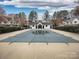 Community pool surrounded by well-maintained landscaping and residential buildings at 11911 Maria Ester Ct, Charlotte, NC 28277