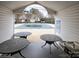 Relaxing poolside view with covered seating area, offering a perfect retreat by the water at 11911 Maria Ester Ct, Charlotte, NC 28277