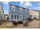Backyard featuring stone patio, outdoor seating and a fire pit, ideal for relaxation and entertaining at 12545 Druids Glen Dr, Pineville, NC 28134