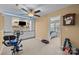 Bright bonus room with built-in shelves, ceiling fan, and exercise equipment at 12545 Druids Glen Dr, Pineville, NC 28134