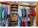 Walk-in closet with custom wood organizers and hanging rods at 12545 Druids Glen Dr, Pineville, NC 28134