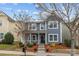 Charming two-story home with a well-manicured front yard and inviting porch at 12545 Druids Glen Dr, Pineville, NC 28134