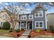 Charming two-story home with a well-manicured front yard and inviting porch at 12545 Druids Glen Dr, Pineville, NC 28134