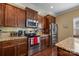 Kitchen with stainless steel appliances, granite counters and wood cabinets at 12545 Druids Glen Dr, Pineville, NC 28134