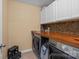 Efficient laundry room with front load washer and dryer and ample counter space for folding at 12545 Druids Glen Dr, Pineville, NC 28134