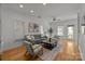 Bright living room features hardwood floors, recessed lighting and neutral color palette at 1335 Summit Greenway Ct, Charlotte, NC 28208