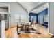 Bright dining area open to living space, showcasing hardwood floors and abundant natural light at 13604 Edgetree Dr, Pineville, NC 28134