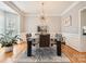 Elegant dining room with stylish light fixture, modern table, and neutral decor at 13604 Edgetree Dr, Pineville, NC 28134