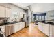 Well-lit kitchen features stainless steel appliances, white cabinets, and a breakfast bar at 13604 Edgetree Dr, Pineville, NC 28134