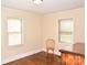 Bright bedroom featuring hardwood floors and natural light from two windows at 1404 Lane Rd, Mount Holly, NC 28120