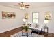 Bright and stylish living room with ceiling fan, wood floors and decorative artwork at 1404 Lane Rd, Mount Holly, NC 28120