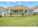 View of the home's backyard with a well maintained lawn and beautiful landscaping at 14920 High Bluff Ct, Charlotte, NC 28278