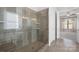 Modern bathroom features a glass shower, beautiful tile, and access to the spacious main bedroom at 14920 High Bluff Ct, Charlotte, NC 28278