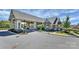 Attractive clubhouse with large windows and manicured landscaping, offering a welcoming entrance on a clear, sunny day at 14920 High Bluff Ct, Charlotte, NC 28278