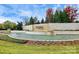 Stone entrance sign with lush landscaping and a tranquil water feature at 14920 High Bluff Ct, Charlotte, NC 28278