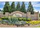 Elegant stone entrance to the Regency at Palisades community with colorful landscaping at 14920 High Bluff Ct, Charlotte, NC 28278