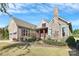 Attractive home with stone accents, red shutters, chimney, and beautifully landscaped front yard at 14920 High Bluff Ct, Charlotte, NC 28278