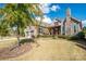 Picturesque home with stone and red shutter details, a two-car garage, and well-kept lawn at 14920 High Bluff Ct, Charlotte, NC 28278