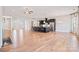 Bright, open living space with a dark kitchen island, hardwood floors, and stainless steel appliances at 14920 High Bluff Ct, Charlotte, NC 28278