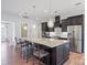 Spacious kitchen featuring a large island with bar seating, granite countertops, and stainless steel appliances at 14920 High Bluff Ct, Charlotte, NC 28278