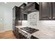 A detailed view of the gourmet kitchen showcasing stainless steel appliances and a modern backsplash at 14920 High Bluff Ct, Charlotte, NC 28278