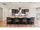 Spacious kitchen featuring a large island with bar seating, granite countertops, and stainless steel appliances at 14920 High Bluff Ct, Charlotte, NC 28278