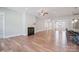Spacious living area with hardwood floors, fireplace, white trim, and views into dining and kitchen at 14920 High Bluff Ct, Charlotte, NC 28278