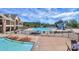 Community pool area showcasing a slide, swimming pools, lounge seating, and nearby clubhouse at 14920 High Bluff Ct, Charlotte, NC 28278
