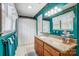 Bright bathroom with teal walls, featuring a large vanity and ample natural light from multiple windows at 1625 Saint Paul Church Rd, Salisbury, NC 28146