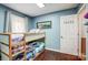 Bedroom with bunk beds and a wooden frame, complemented by hardwood floors and a serene blue wall at 1625 Saint Paul Church Rd, Salisbury, NC 28146