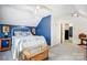 Bedroom featuring a white iron bed frame with a blue accent wall, creating a cozy space at 1625 Saint Paul Church Rd, Salisbury, NC 28146