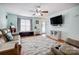 Bright living room with hardwood floors, modern furniture, and a mounted TV, perfect for relaxation at 1625 Saint Paul Church Rd, Salisbury, NC 28146