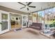 Relaxing screened porch with a swing, ceiling fan, and seamless transition to the home's interior at 1625 Saint Paul Church Rd, Salisbury, NC 28146